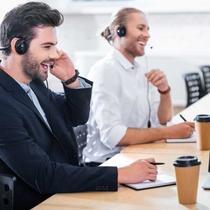 side view of male call center operators in headsets at workplace in office transformed